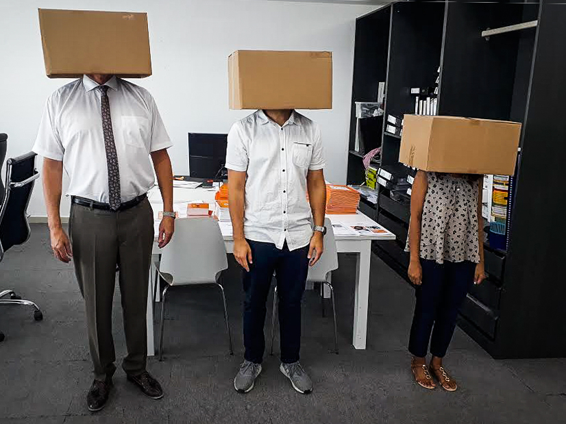 Rob, Rodrigo and Pragya with boxes on their heads